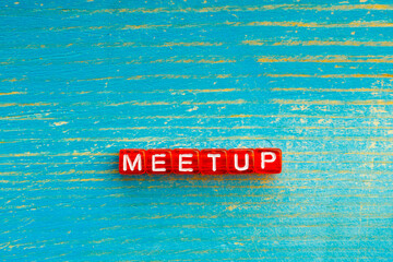 meetup written on red cubes the background is blue