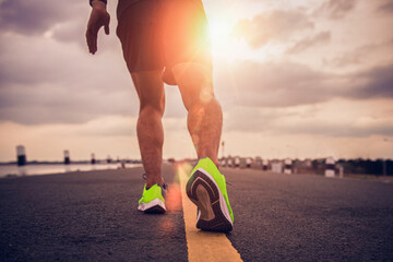 Sports background. Runner feet running on road closeup on shoe. Concept of running and fitness for health.