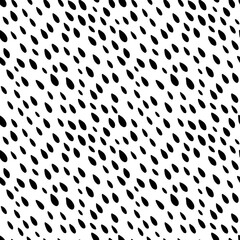 Abstract all over seamless repeat pattern with slanted raindrop shape spots. Black and white ditsy background