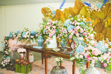 cake table decorated with flowers for wedding