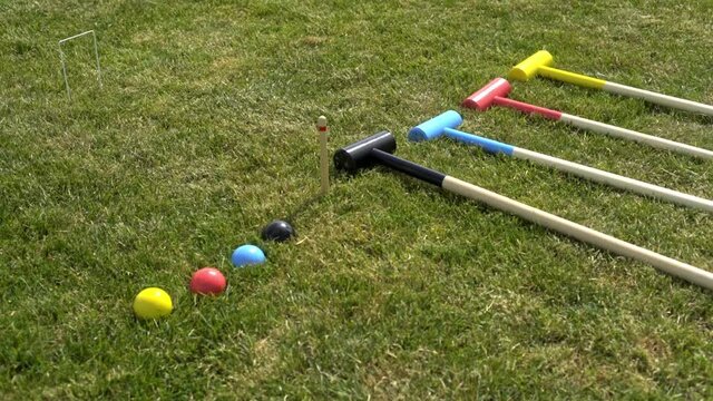 Croquet equipment is lying on the green lawn