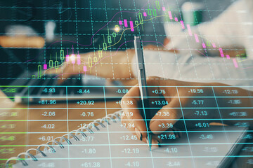 Double exposure of forex chart drawing over people taking notes background. Concept of financial...