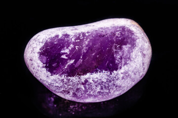 Macro mineral amethyst on a black background