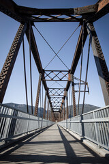 Steel bridge over a walking path.