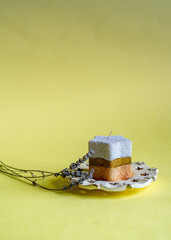 Lavender and colorful candle on yellow background