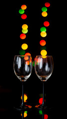 Two empty glasses and colorful light