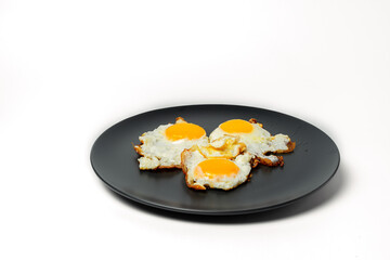 Scrambled eggs from 3 eggs on gray plates on white background
