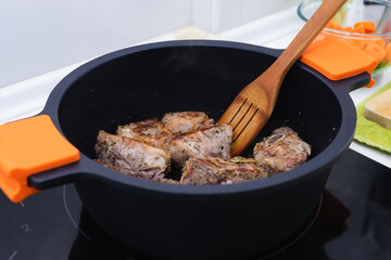Process of sealing meat in a pot. Cooking concept.