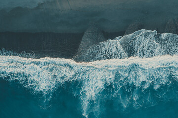 Naklejka na ściany i meble Aerial view of oacean wave at sunset