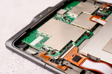 Fototapeta premium Interior of a small electronic device, with motherboard and transistors exposed.