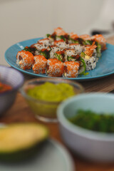 Close up of Sushi Roll set on a plate, ingredients around. Still life