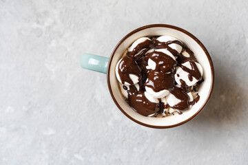 Very tasty hot cocoa mug sprinkled with marshmallows and hot chocolate. Top view.