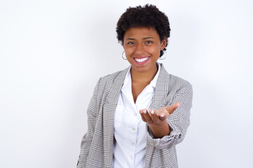 African American businesswoman with curly bushy hair wears  formal clothes over white background...