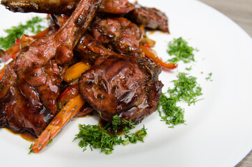 grilled lamb ribs with vegetables on a white plate