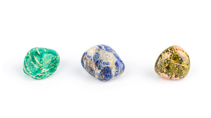 Three different colored gemstones on white background, front view. Lithotherapy, chakra balancing, crystal ritual.