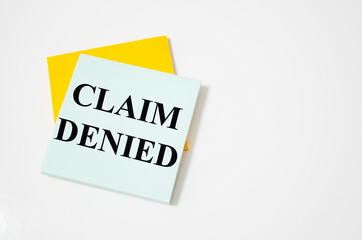 claim denied the text is written on a white notepad with colored pencils and a yellow background