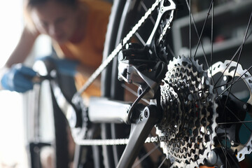 Master repairman repairing bicycle in workshop closeup