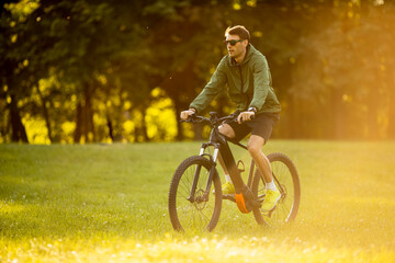 Young man riding ebike in the park