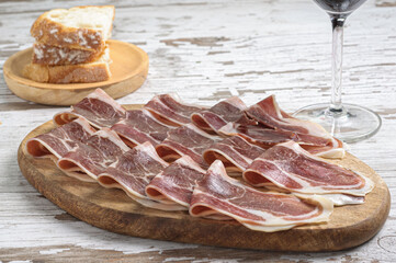 sliced ham on wooden board