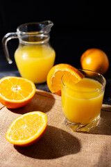 Fototapeta na wymiar table full of fresh oranges and juice in springtime