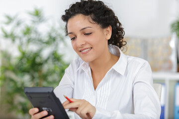 female with calculator in office