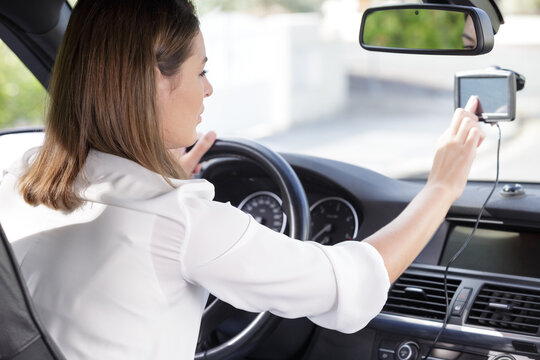 Woman Using Gps Navigation System In Car