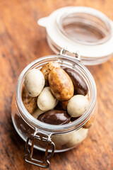 Sweet chocolate almonds. Chocolate eggs in jar.