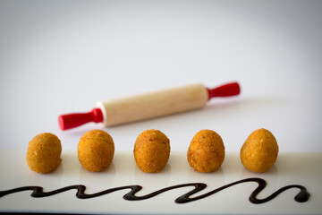 Homemade traditional Spanish croquettes or croquetas on a white background