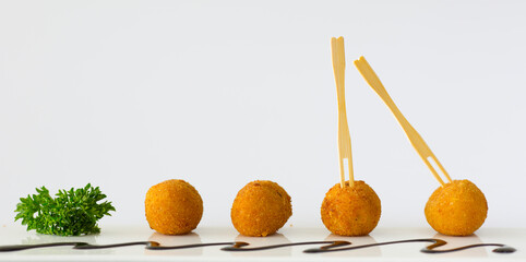 Homemade traditional Spanish croquettes or croquetas on a white background