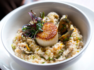 seafood risotto with scallops and clamps