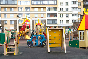 Naklejka premium A colorful children playground in the city near a residential building