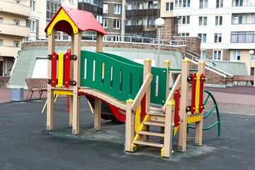 Fototapeta na wymiar A colorful children playground in the city near a residential building