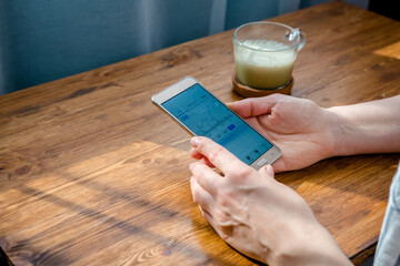 Investments. The girl investor buys shares and analyzes the stock exchange, remotely invests the budget in shares. Work from home to quarantine, Work remotely. Investment market, stocks and funds.