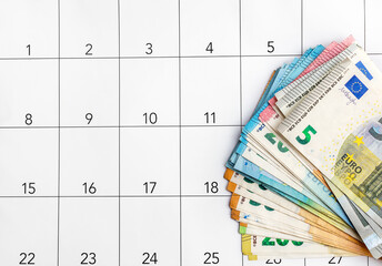 Different bills of euro on calendar. Business concept. Deadline of payment.