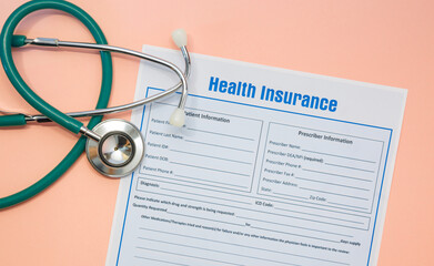 Health insurance with insurance claim form and stethoscope.