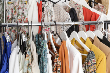 Women's fashion. Different clothes on hangers, close up.	