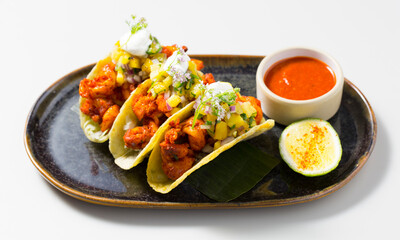 Pork tacos with mango and onion
