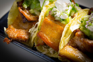 pork belly tacos served with guacamole