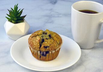 blueberry muffin with a cup of coffee