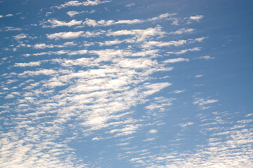 Naklejka na ściany i meble Tapeta kompozycja białych delikatnych chmur na niebieskim niebie 