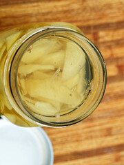 Sliced ginger pickling in the glass jar, close-up