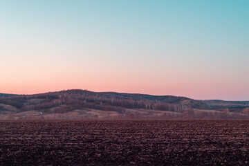 Fototapeta na wymiar Mountain field and sunset in the sky in autumn.