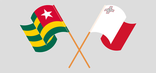 Crossed and waving flags of Togo and Malta