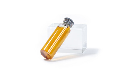 Glass transparent bottle with liquid medicine. Transparent amber color vial with lid
