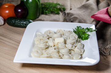 dumplings with meat on white plate. russian pelmeni. 