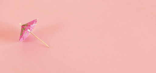 Side view of cocktail sun umbrella. Pink Drink Umbrella Isolated on pink Background. © Marcela Ruty Romero