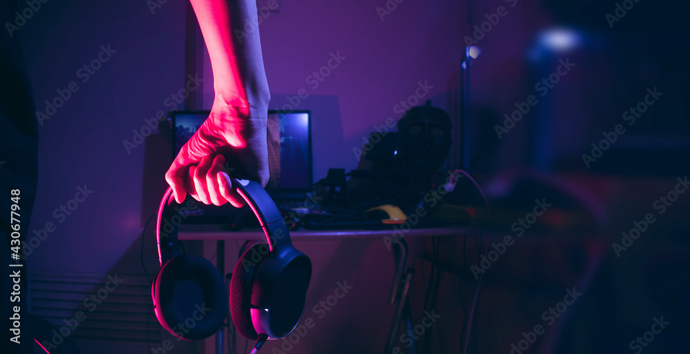 Canvas Prints gamer holding headphone with computer for playing a game, gaming and esports conept