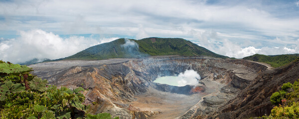 Panorama of Fumarole smoke over the Poas Volcano in Costa Rica in 2012. Detail of the acid water...