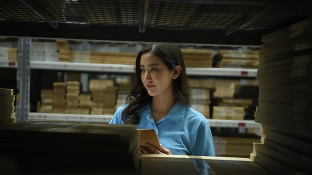 Business concept of 4k Resolution. Asian women intently inspecting items in the warehouse.