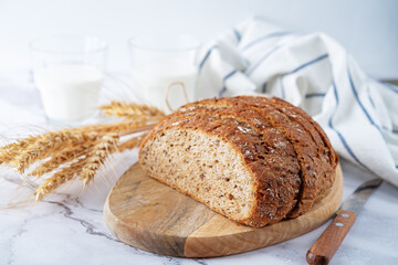 Wholegrain rye bread with glasses of milk